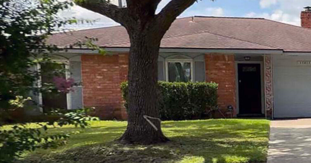 Red Brick Suburban Ranch House in Sugar Land TX large oak tree in yard and two car driveway