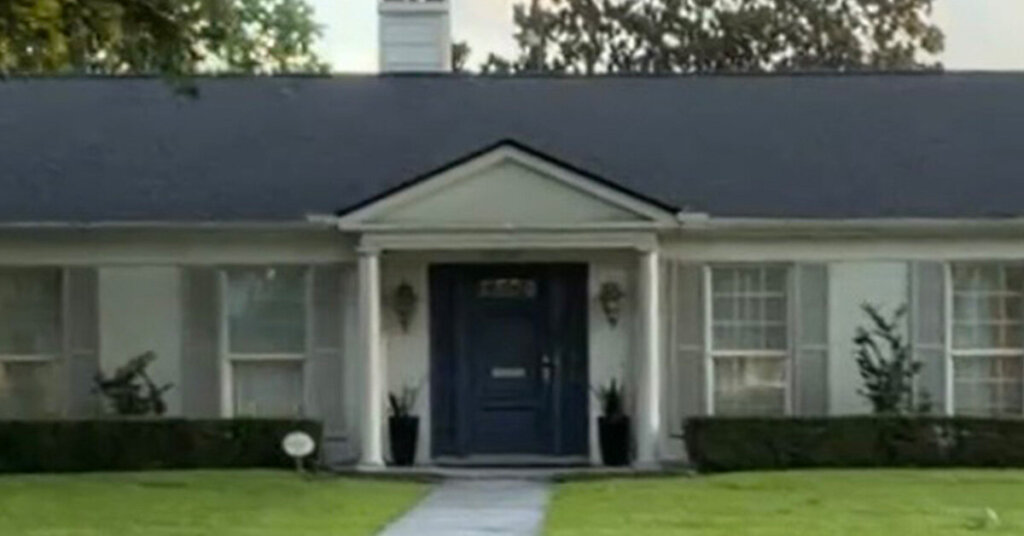 White Brick Suburban Ranch House in Baytown TX with mowed front yard and gabled front porch with two Greek columns