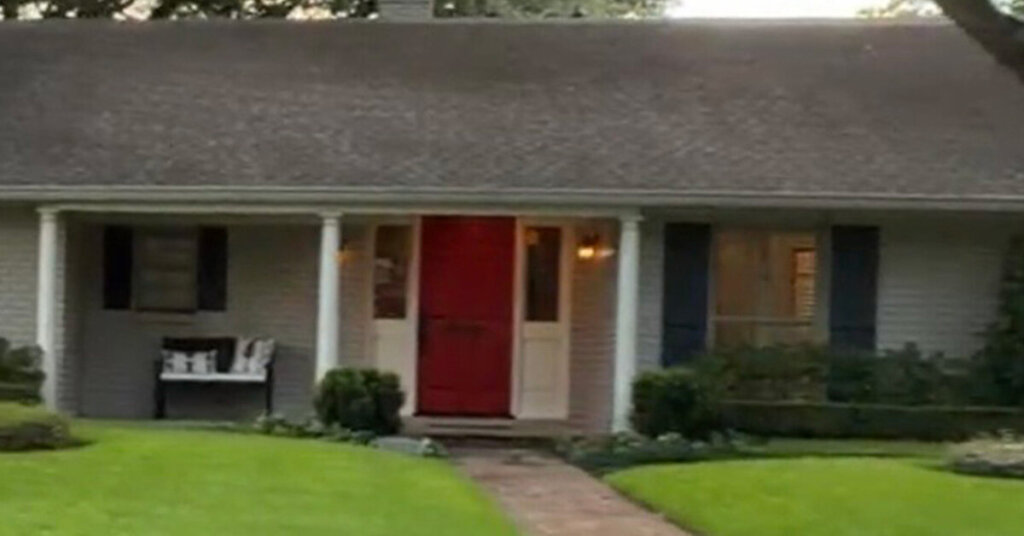 White Brick Suburban Ranch House in Deer Park TX with manicured front yard and red door with white side highlights