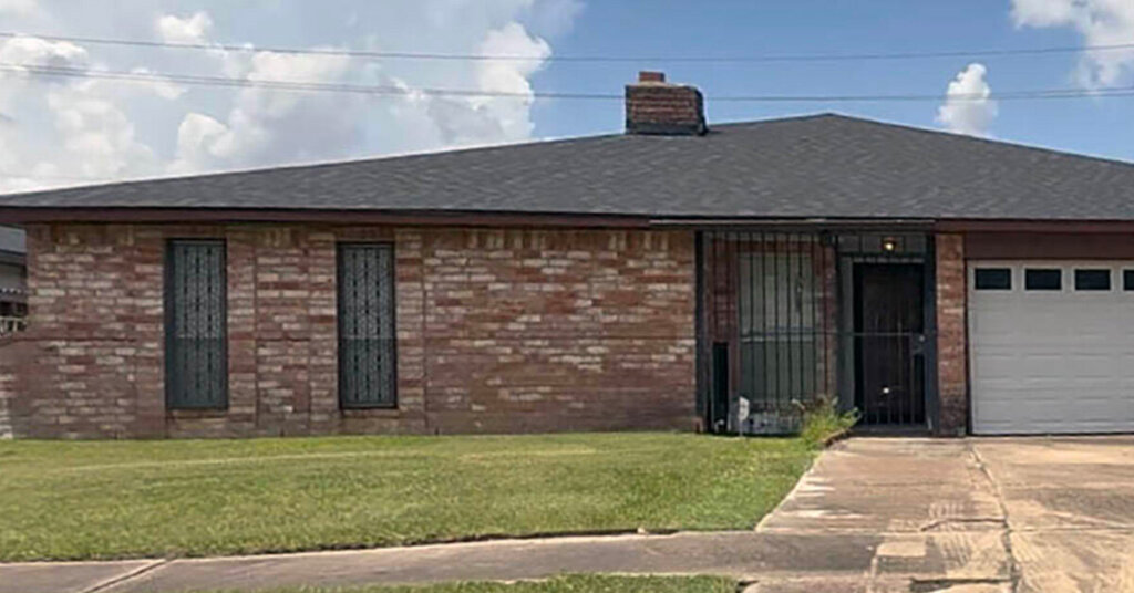 White and Red Brick Suburban Ranch House in Spring TX with hip roof and two car driveway