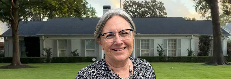 becky fields the grandma house buyer in front of a Baytown TX ranch house