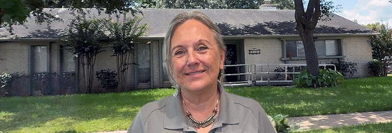 becky fields the grandma house buyer in front of a Pearland TX ranch house
