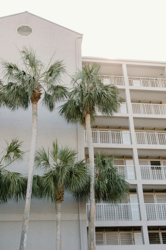 Coastal condominium balconies framed by palm trees