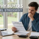 Northern Virginia homebuyer reviewing mortgage loan estimate and closing cost paperwork at a kitchen table.