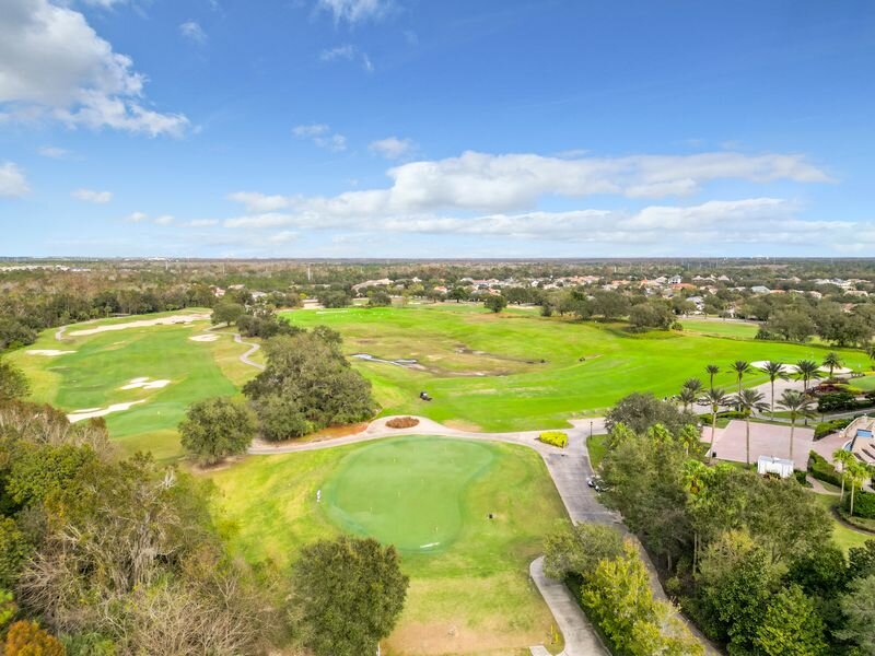 Scenic aerial shot of lush Reunion Resort golf course with nearby homes in Orlando area