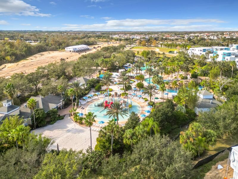 Aerial view of tropical water park and splash zone with palm trees at Reunion Resort