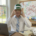 Bergen County New Jersey real estate agent reviewing home values with maps, pricing notes, and market data at his desk