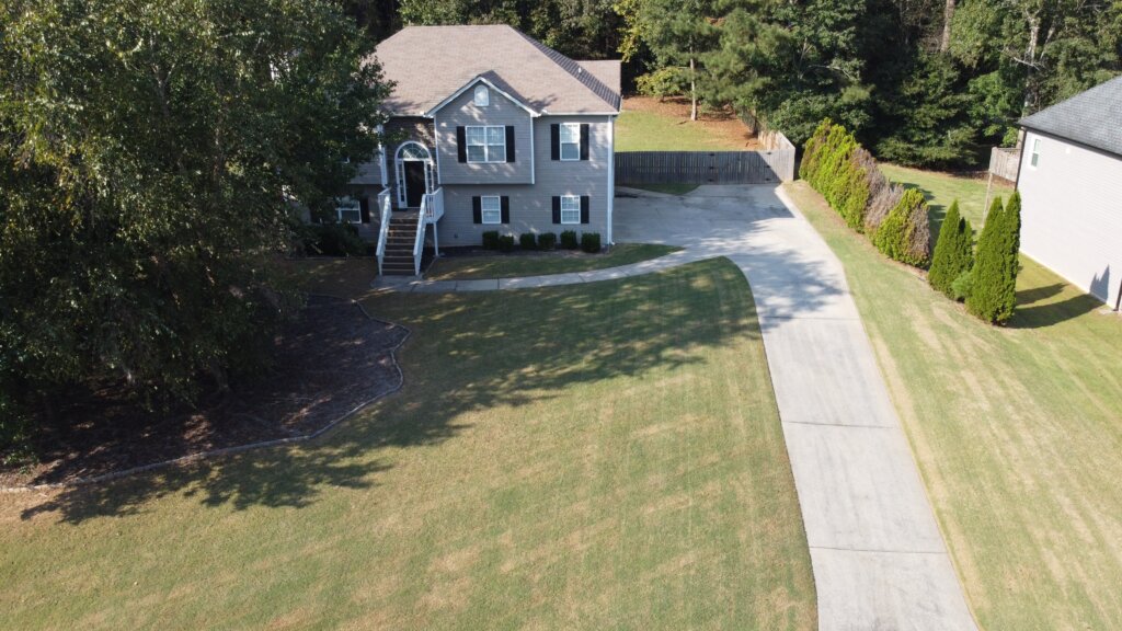 Aerial view of a two-story home in Villa Rica, Georgia with a large, open yard.