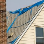 A house for sale in Rome, GA with visible roof damage.