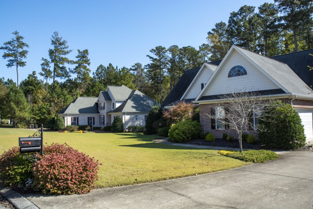 Two charming homes in a quaint neighborhood in Rome, GA, featuring well-kept exteriors and a peaceful, inviting atmosphere.