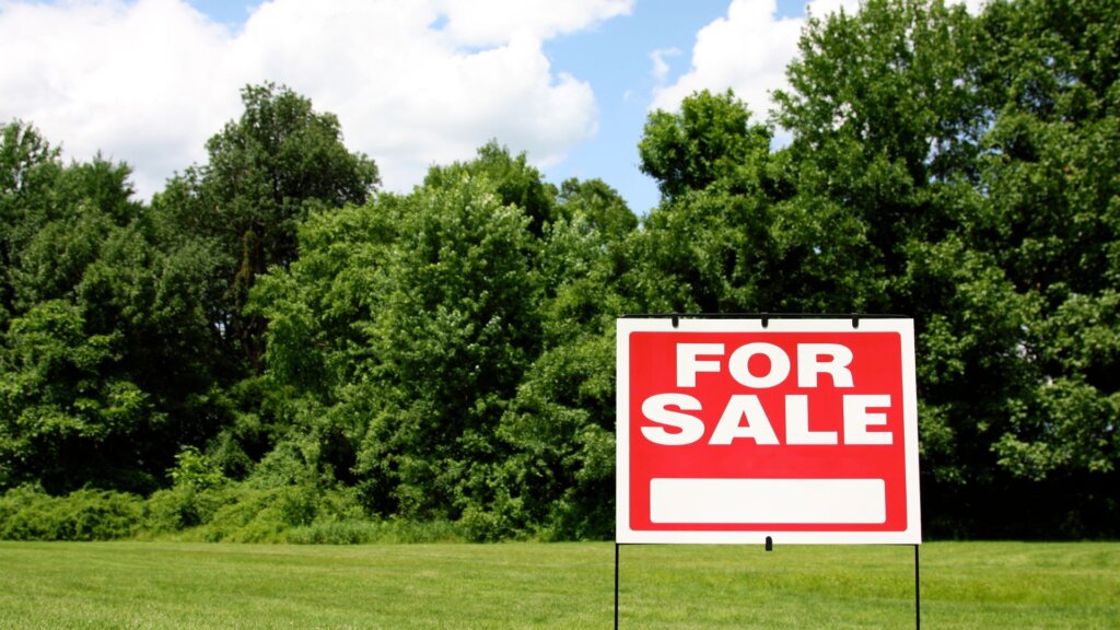 Land for sale with a for sale sign.