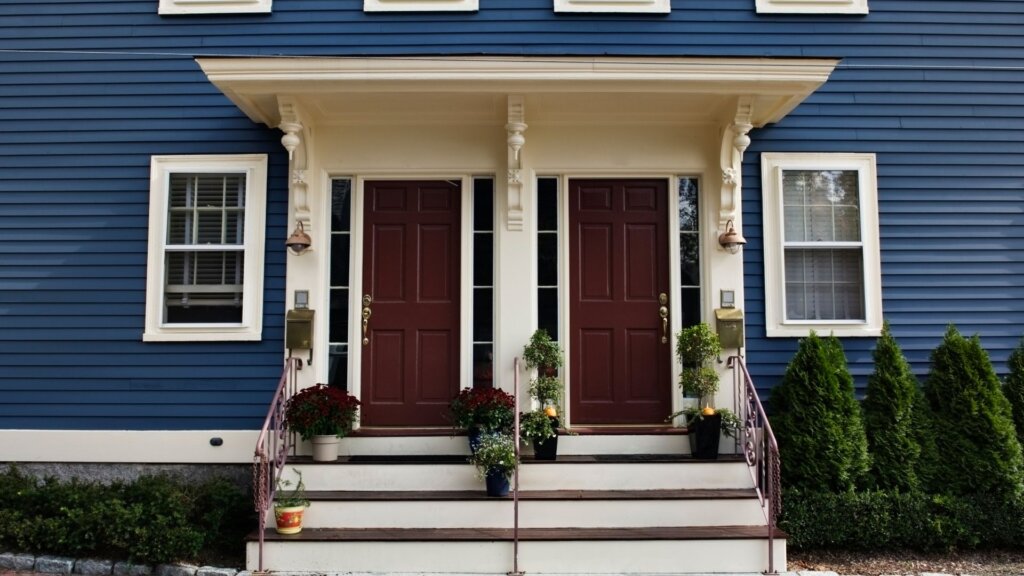 Exterior of a modern duplex home with two separate entrances.