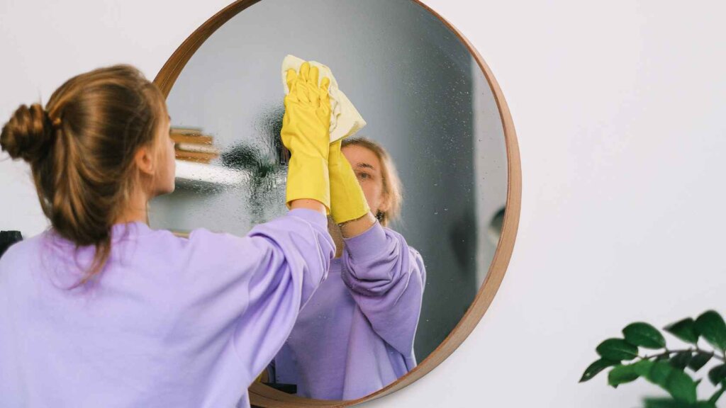 Woman cleaning house to prepare for home sale in Georgia. 