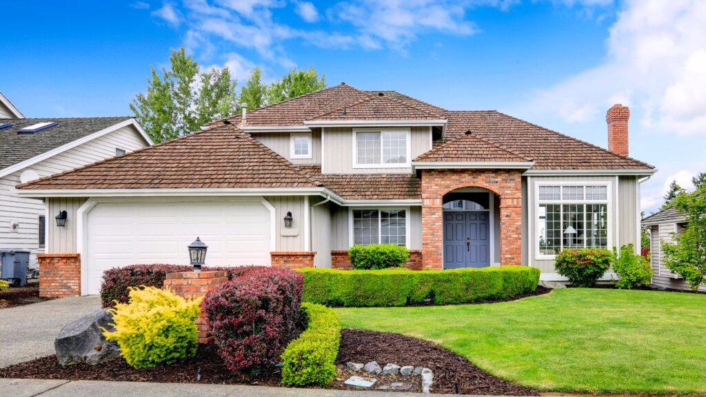 Large home with beautiful plantings in the front yard 