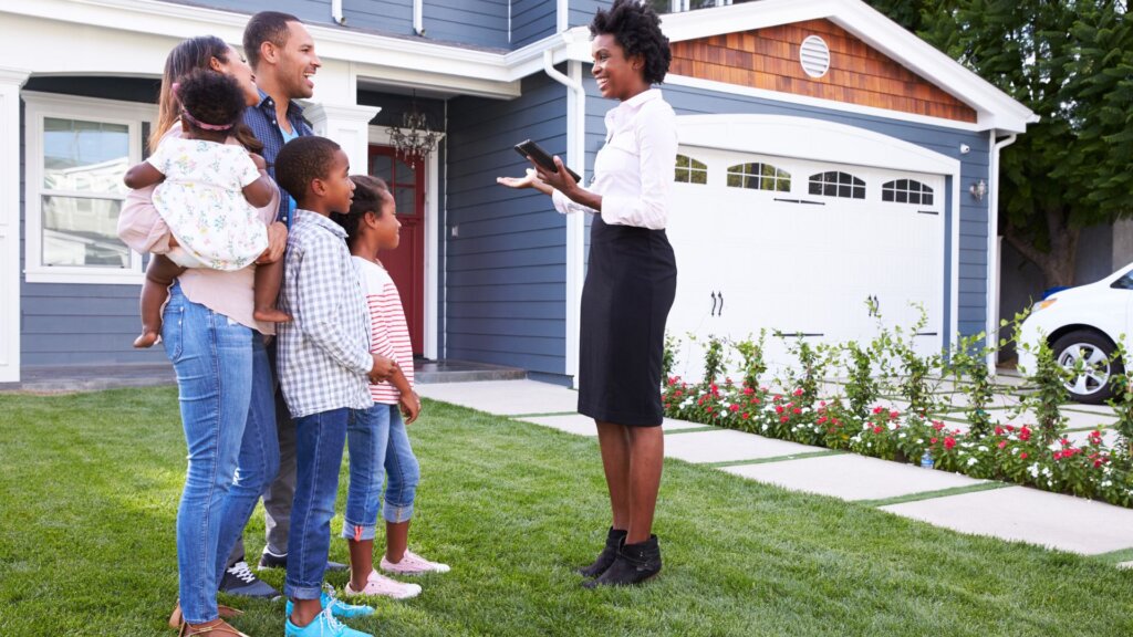 Real estate agent talking with a family.