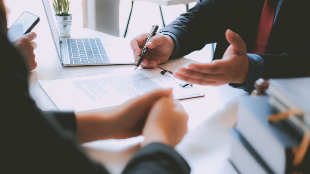 Photo of a lawyer and a buyer at a real estate closing.
