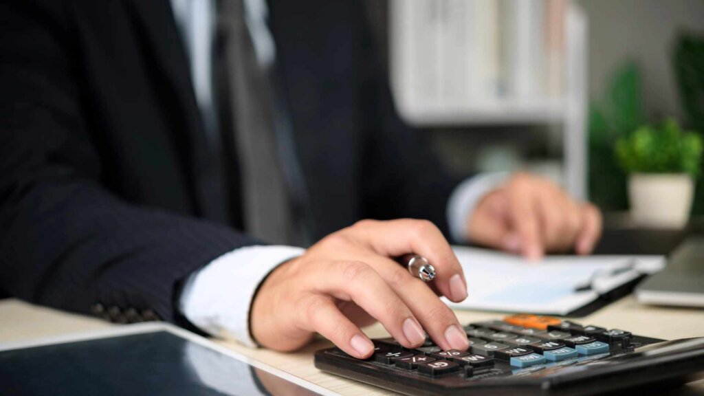 Real estate agent calculating value of home