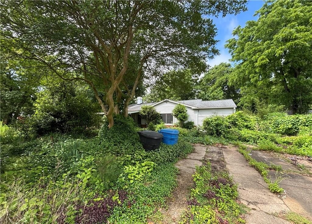 Overgrown, neglected house on Ferry Plantation Road in Aragona Village, Virginia Beach that O’Neill Home Buyers bought as-is for cash