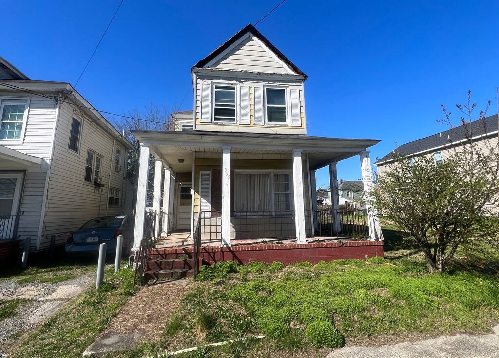 Two-story house on Roanoke Avenue in Newport News, VA that O’Neill Home Buyers bought as-is after a tree fell through the back