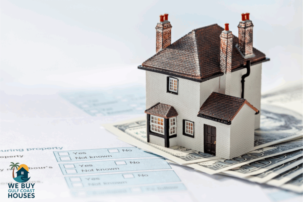 Model house on cash and documents representing selling a Florida home and tax paperwork.