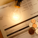 A lightbulb, utility bill, and coins symbolize rising costs and power shutoffs in Lee County, FL.