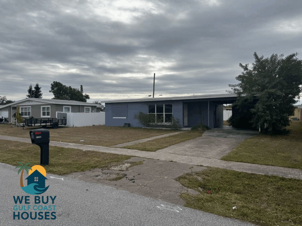 Port Charlotte FL probate house purchased by We Buy Gulf Coast Houses featuring single-story concrete block home with carport and large front yard in quiet residential neighborhood.
