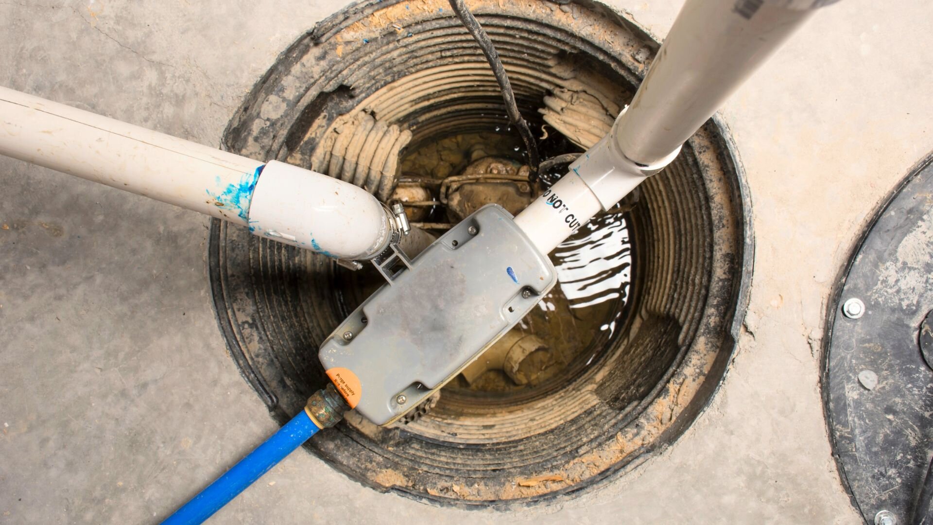 Sump pump installation in basement.