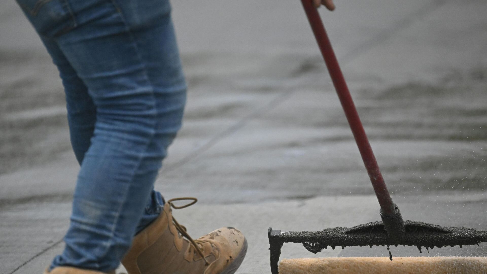 Contractor appealing sealant to concrete.