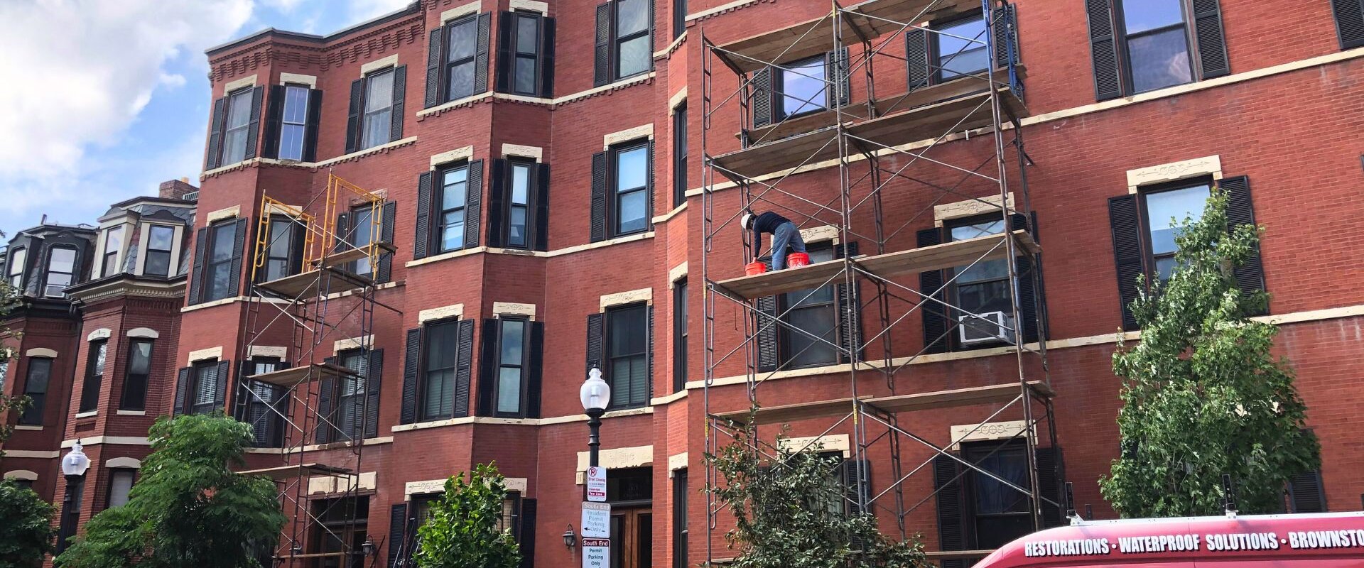 Exterior of a multi-story, brick apartment building.