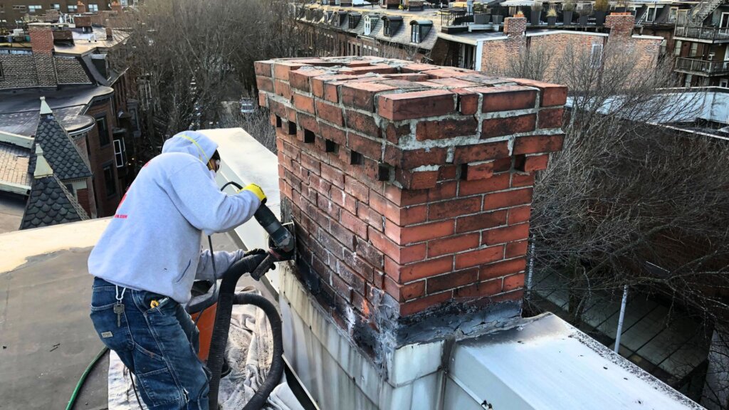 Contractor working on chimney in Boston, MA.
