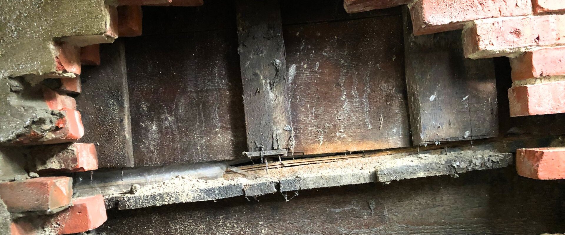 Exposed foundation in side of house.