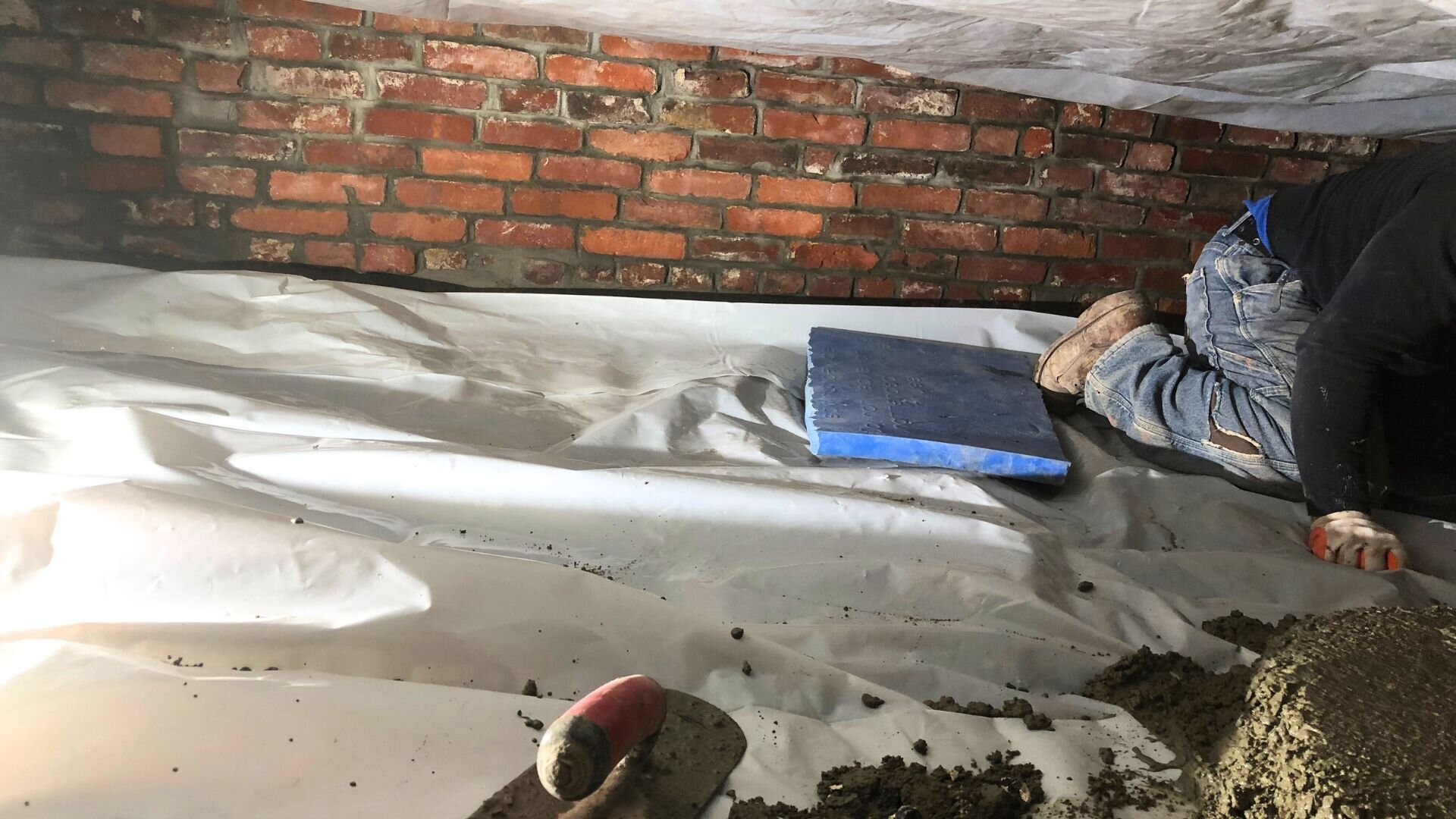Contractor waterproofing crawl space in Boston, MA.