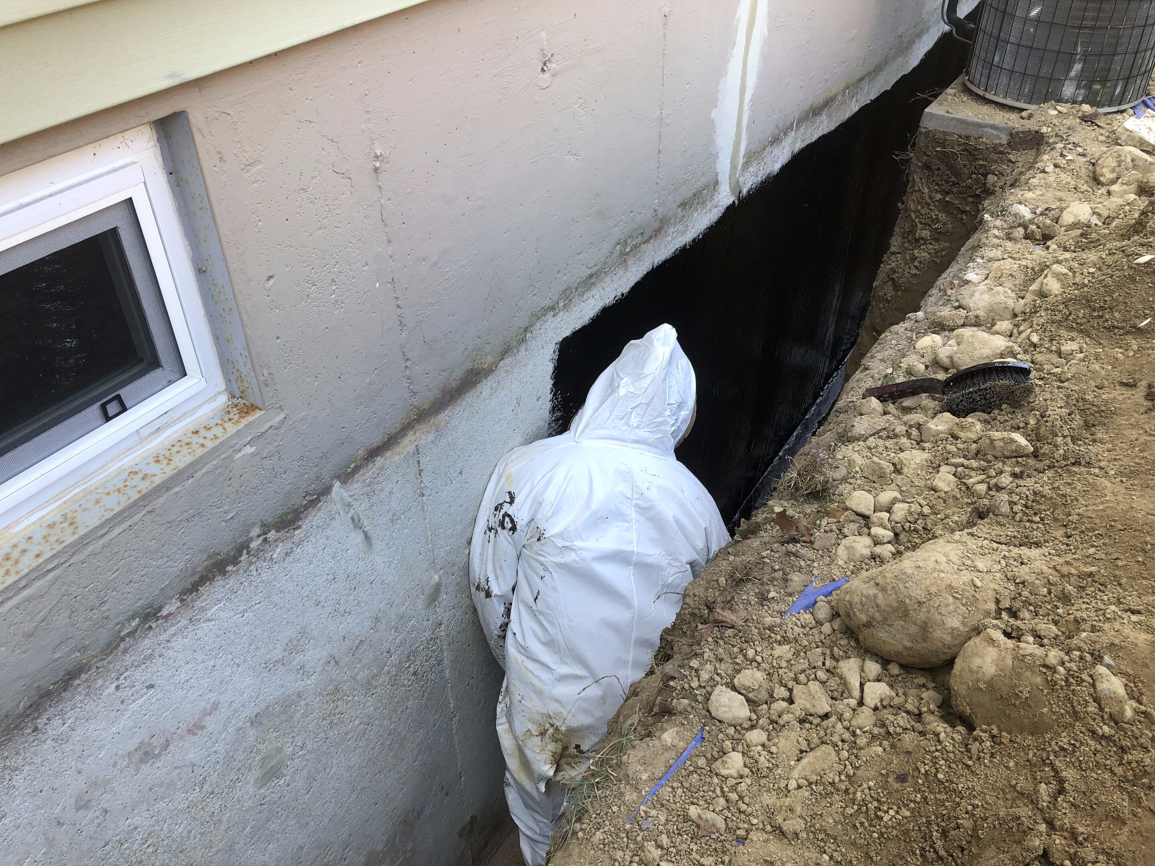Contractor waterproofing concrete foundation in Boston, MA.
