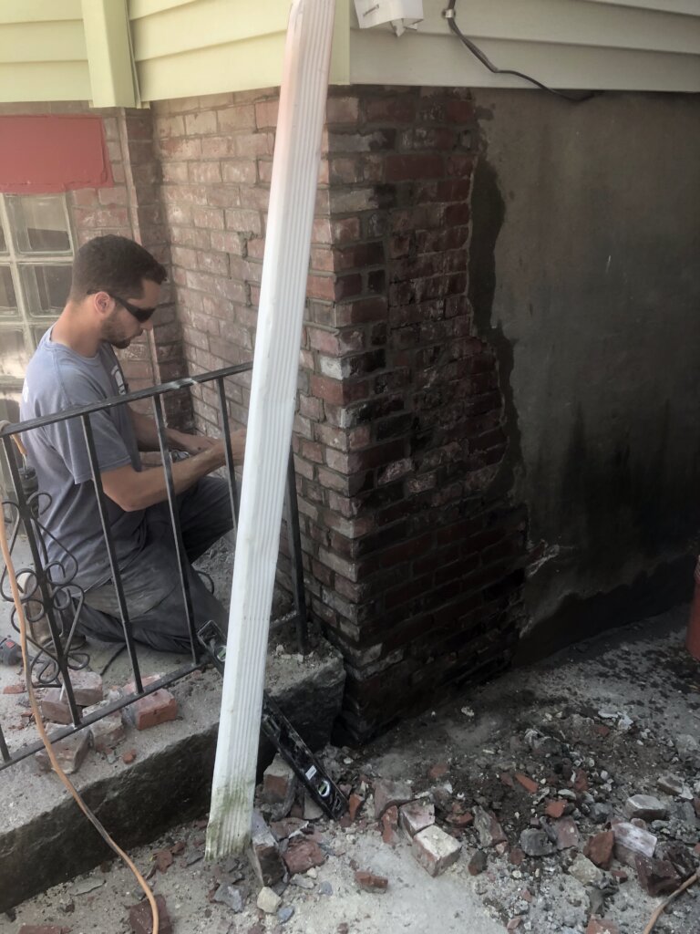 Contractor working on foundation of home in Cambridge, MA.
