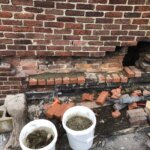 Chimney under repair with several missing bricks.