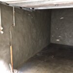 Basement interior with waterproofing material applied to the walls to prevent moisture intrusion.