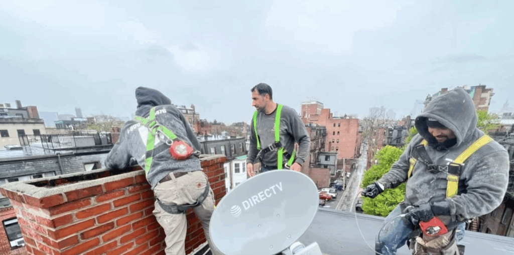 Masonry team working on the roof of a home in Boston, MA.