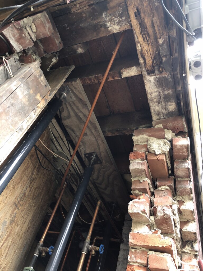 Demolition work underway during a brick foundation repair project