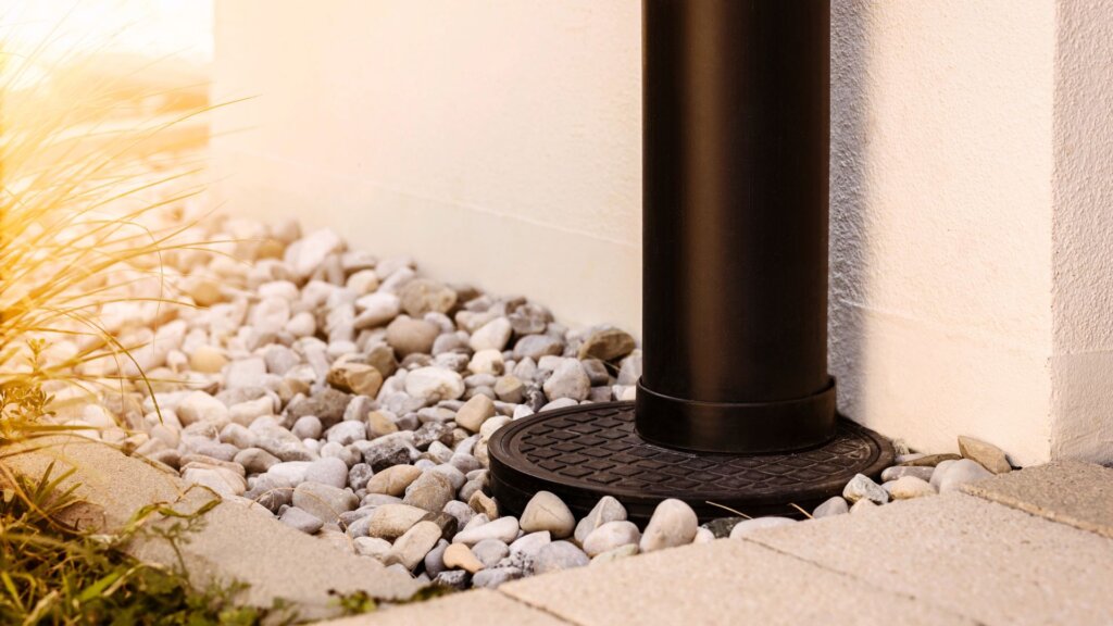 Downspout connected to a foundation drainage system that helps prevent water from collecting near the home