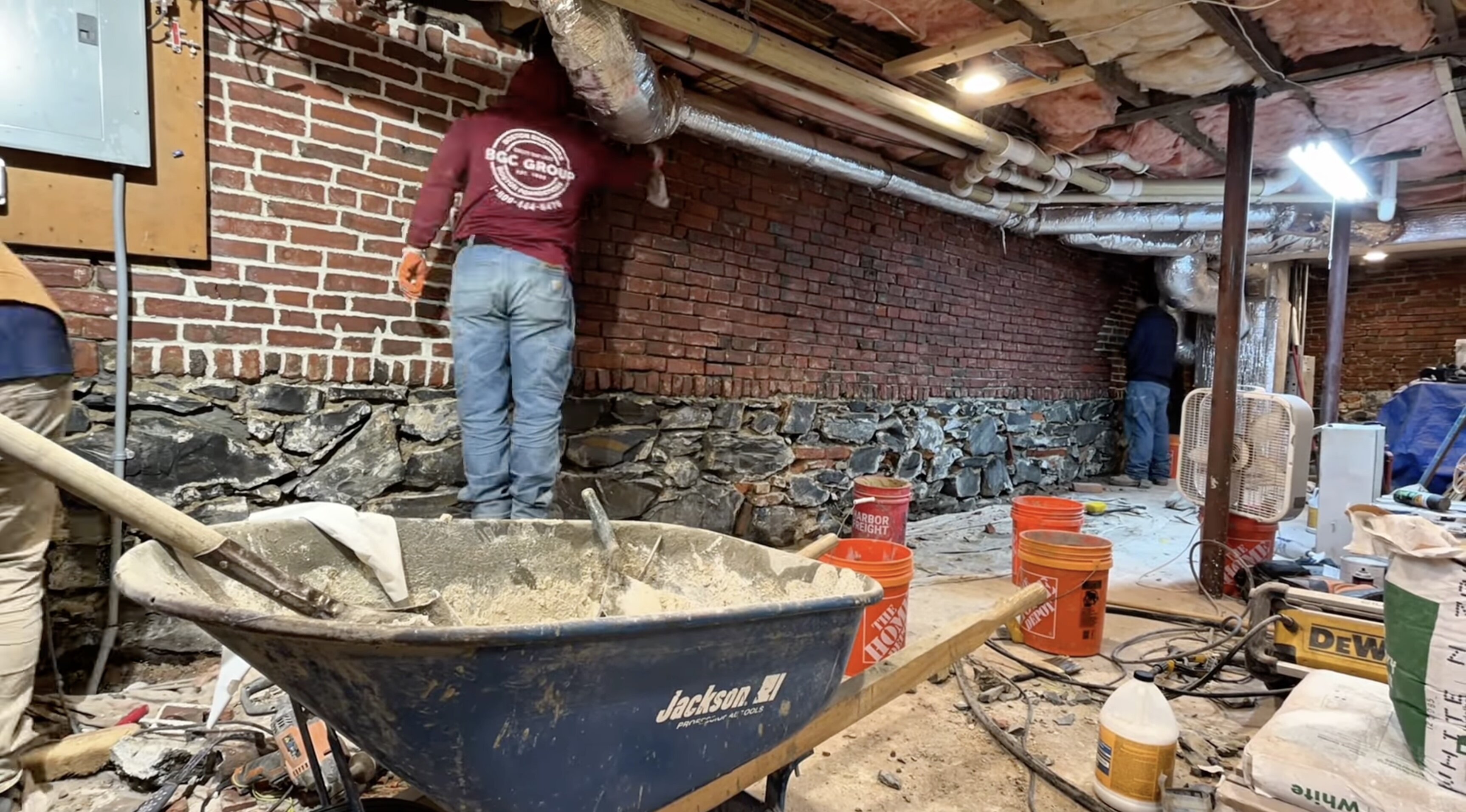 Basement transformation project in progress with structural improvements and masonry restoration