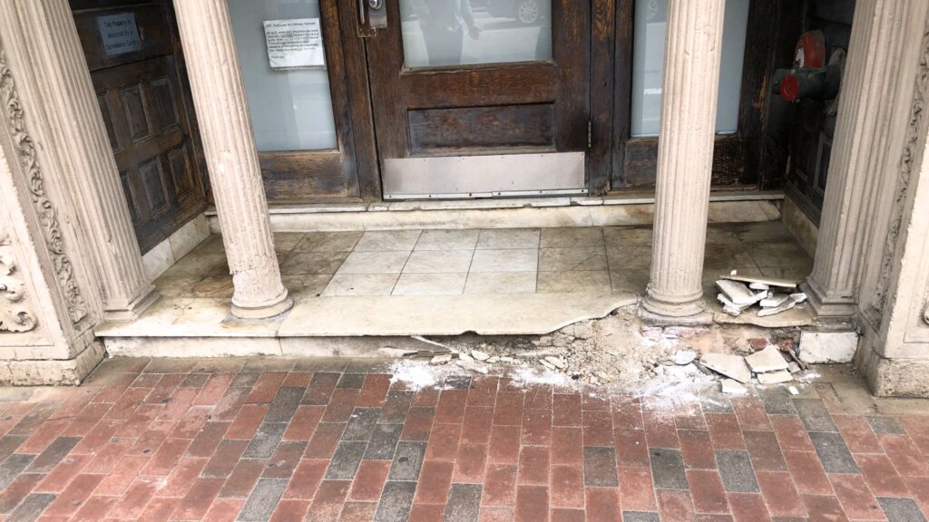 Damaged stone entryway undergoing restoration at a historic Boston, MA building