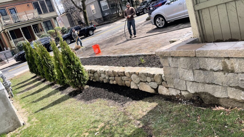 Natural stone retaining wall and landscape masonry project at a residential property in Boston, MA