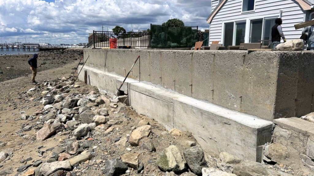 Repaired concrete seawall along a Massachusetts shoreline