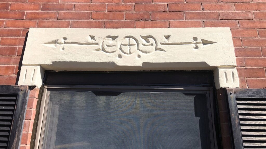 Restored decorative stone lintel above a window on a historic brick building in Boston, MA