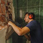 Man installing drywall during a home renovation project