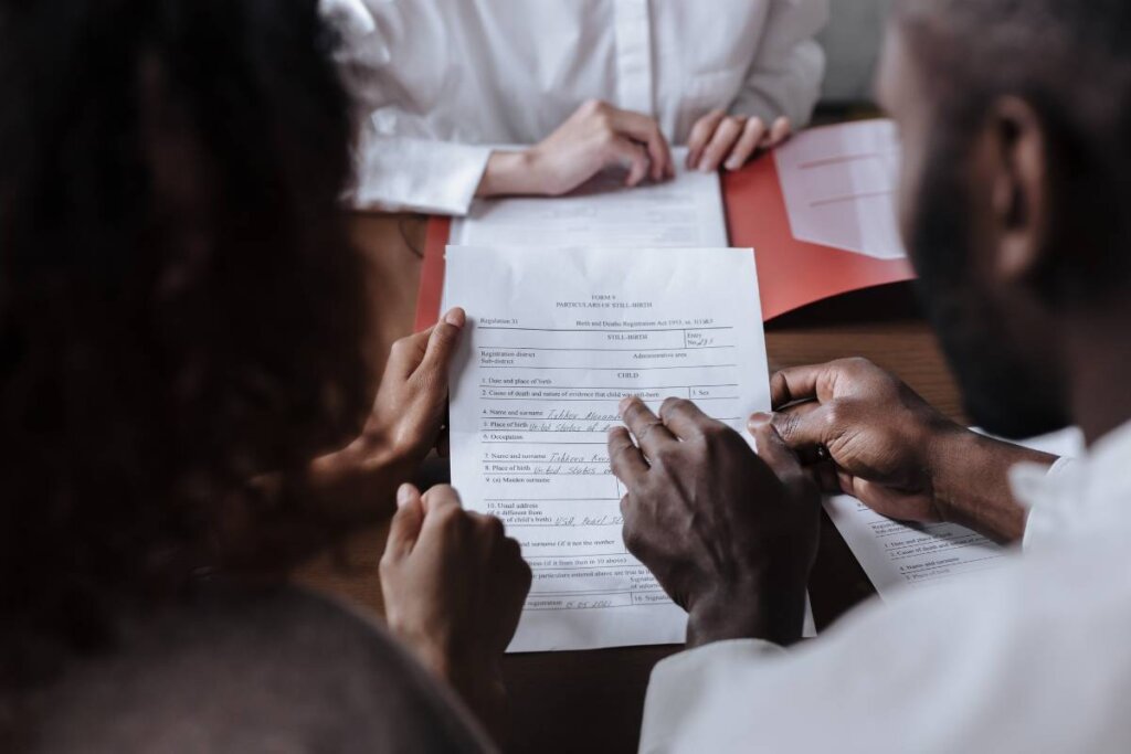 Family members signing legal paperwork during the Pennsylvania probate process to sell an inherited house