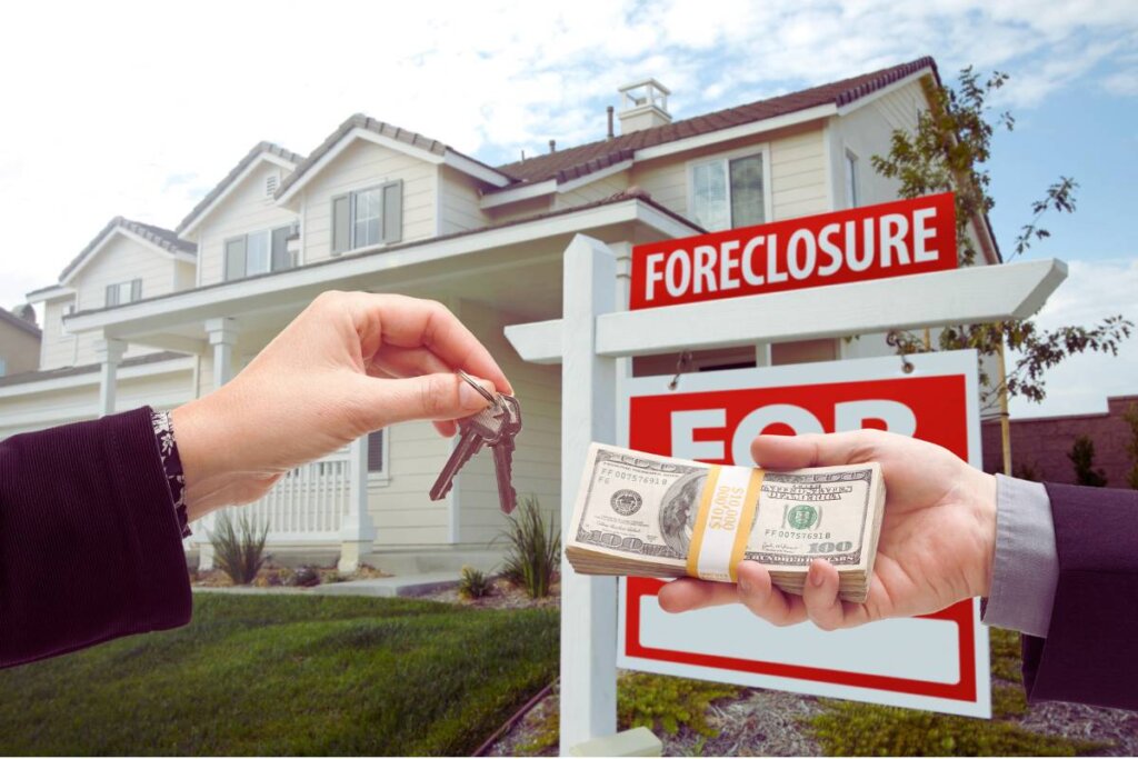 Cash being exchanged in front of a house sale sign