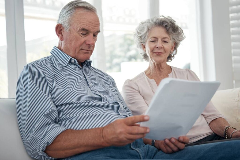 Older couple reviewing home sale paperwork in Pennsylvania living room