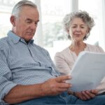 Older couple reviewing paperwork to sell their Pennsylvania home