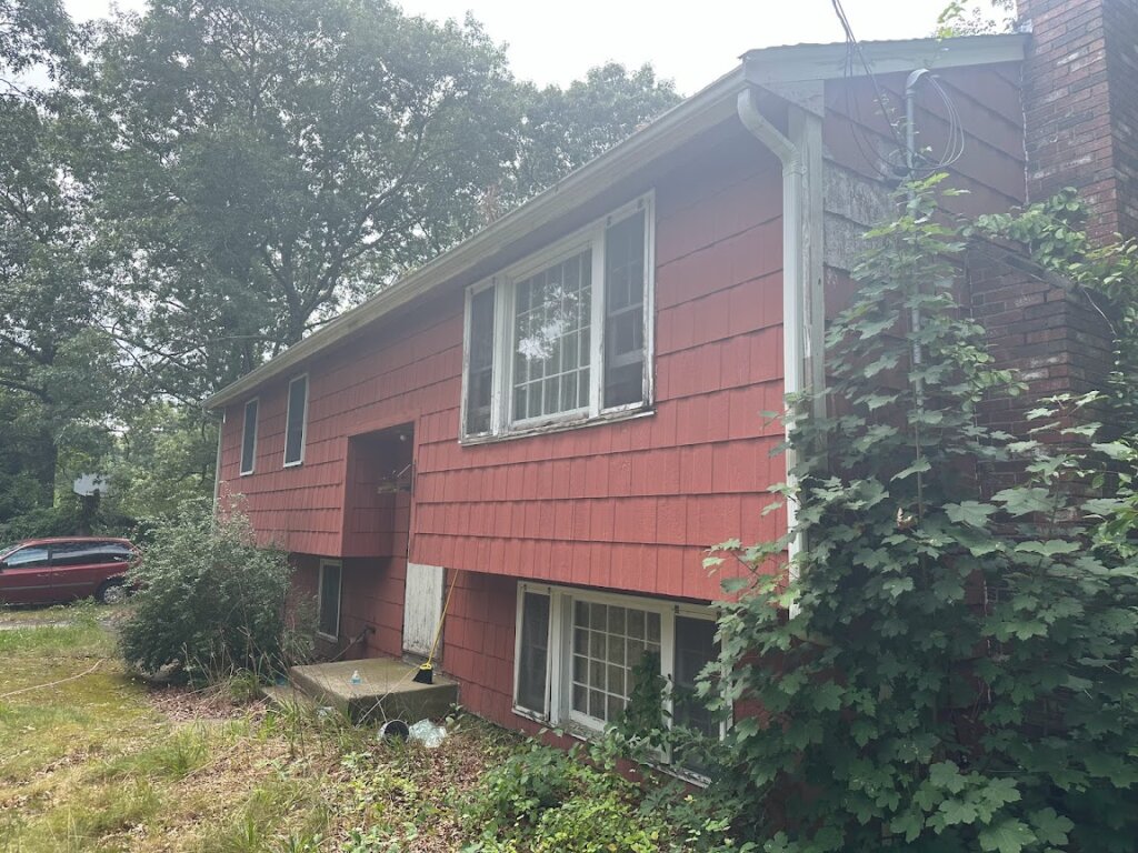 Side view of distressed home at 37 Montgomery Drive prior to rebuild